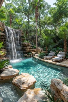 an outdoor swimming pool with waterfall and chaise lounges next to it, surrounded by palm trees