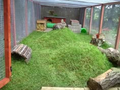 a rabbit house with grass and rocks in it