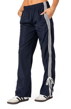 Sporty stripes trail the sides of these wide-leg track pants detailed with ties and topped with a comfortable elastic waist. 100% polyester Machine wash, dry flat Imported Visionary Fashion, Sweatpants Women, Casual Pants Style, Striped Sweatpants, Korean Clothing, Pants Details, Clothing Pants, Y2k Baggy, Hip Hop Streetwear