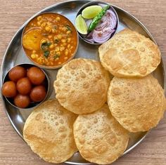 a metal plate topped with different types of food