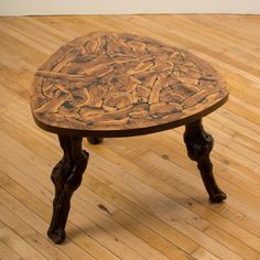 a wooden table sitting on top of a hard wood floor