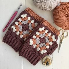 a crochet granny blanket with scissors and yarn