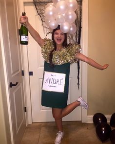 a woman in a green dress is holding up balloons and a sign that says the bride