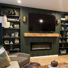 a living room filled with furniture and a flat screen tv mounted on the wall above a fire place