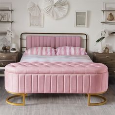 a pink bed sitting in the middle of a bedroom