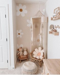 a room with flowers painted on the wall, and a hammock hanging from the ceiling