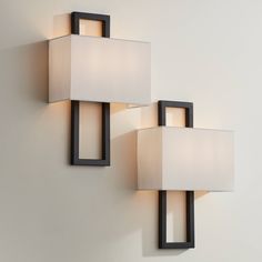 two square lights are mounted on the wall