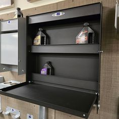 a black shelf with two bottles on top of it