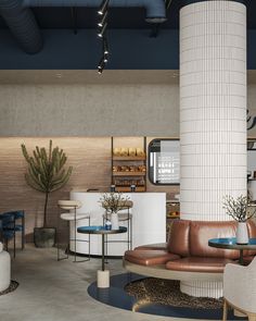 a living room filled with lots of furniture next to a tall white brick pillar in the center