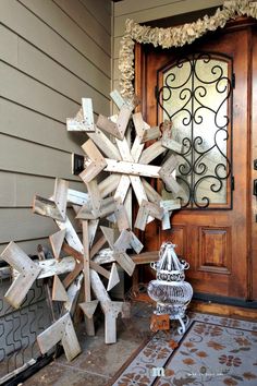 a wooden snowflake sitting on top of a porch next to a brown door