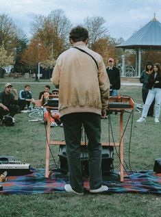 a man standing on top of a picnic table