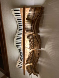 a wall hanging made out of strips of wood