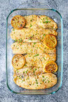 baked lemon butter tilapia in a glass baking dish with the title above it