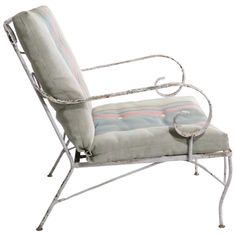 a chair that is sitting on some kind of metal frame with a striped seat cushion