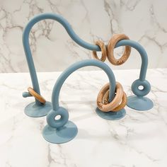 two wooden rings are attached to the handles of an object on a marble countertop