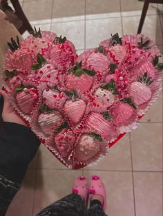 a heart shaped box filled with chocolate covered strawberries in the shape of a heart