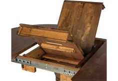 an open wooden box sitting on top of a table next to a drawer with it's lid opened