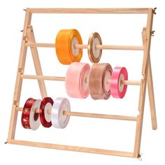 a wooden rack with multiple spools of thread on it