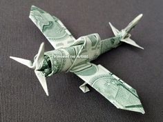 an origami airplane made out of one dollar bill