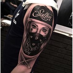 a man's arm with a tattoo on it that has a woman wearing a motorcycle helmet