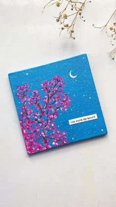 a blue notebook with pink flowers and a moon on the cover that says, you're my home