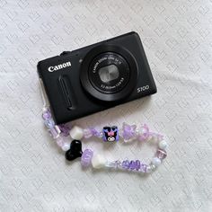 a camera and some beads on a table