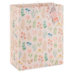 a small pink shopping bag with an animal on the front and floral designs on the side