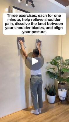 a man is painting the wall with white paint on it and has his hands up in front of him