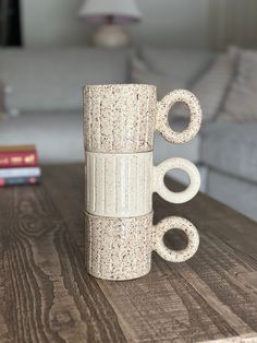 a coffee cup made out of cork sitting on top of a wooden table