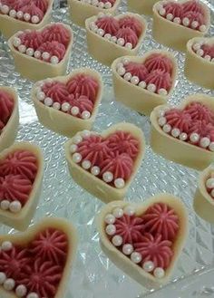 many heart shaped cookies with pearls on them