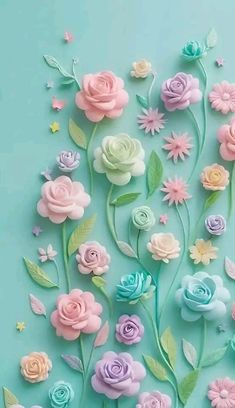 an image of flowers made out of fondant and pastel colors on a blue background