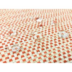 some orange and white checkered fabric with small diamonds on it