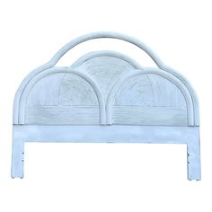 a white headboard with two circular designs on the top and bottom, against a white background