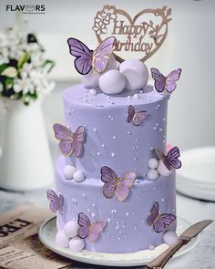 a purple cake with butterflies on it