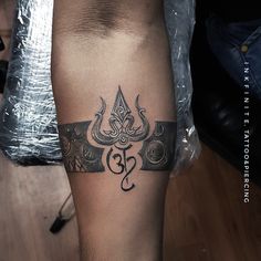 a tattoo on the leg of a man with an omen symbol in black ink