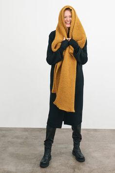 Make your style A LOT cozier with our extra-long Bronx Scarf. Bronx is both knit from ultra-soft French Merino Wool mix to warm your soul and fashioned extra long to make a statement. Wrap this Merino wool scarf around and around for volume, or wear her draped over your shoulders to lend your look texture and drama. This soft wool scarf also doubles perfectly as an airplane blanket. | Emmy, in burnt yellow, is 5'10.5" (179 cm), wearing size XS. Natalee, in medium grey, is 5'10" (178 cm) tall. As Wide Crochet Scarf, Knit Scarf Outfit, Burnt Yellow, Airplane Blanket, Super Scarf, Chunky Infinity Scarves, Big Scarf, Merino Wool Scarf, Yellow Scarf