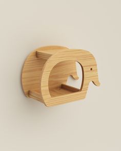 an elephant shaped wooden shelf on the wall