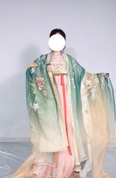 For the spring fairy, this gorgeous Tang Dynasty inspired set is adorned head to toe with embroideries of lotuses, mandalas and peacock feathers. Not one corner is neglected! From the wrists to the back, envelop yourself in the luxuries of high quality flowers. The Daxiushan (大袖衫, wide sleeved jacket) is dramatic and elegant, creating movement and grace with its exaggerated sleeves. Layer the embroidered jacket over the sheer jacket for a dimensional effect. The star of the show is the Heziqun ( Traditional Spring Wedding Hanbok, Traditional Ceremonial Sets For Spring, Lotus Fairy, Tang Dynasty Clothing, Chinese Female, Fanfic Ideas, Modern Kimono, Modern Hanfu, Spring Fairy