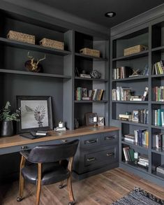 a home office with built in bookshelves and desk