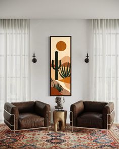 a living room with two brown leather chairs and a cactus painting hanging on the wall