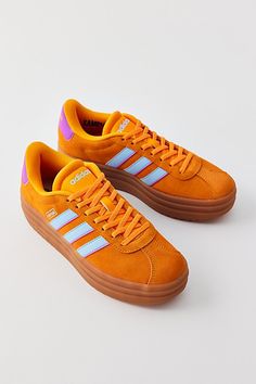 adidas VL Court Bold sneakers - a bold suede sneaker from adidas set on a platform sole. Features adidas VL Court Bold sneakers Elevated adidas shoes Suede platform sneakers Classic adidas stripes at the side Comfy padded insole Platform sole Lace-up sneaker style Content + Care Suede, synthetic, rubber Spot clean Imported | adidas VL Court Bold Sneaker in Orange, Women's at Urban Outfitters Orange Sneakers Women, Adidas Platform Sneakers, Platform Sneakers Outfit, Adidas Vl Court, Adidas Set, Orange Fits, Classic Adidas, Orange Sneakers, Sneaker Style