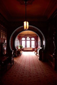 an archway leading into a living room filled with furniture