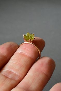 Rough Peridot ring in my best selling lotus flower design. A handcrafted rose gold fill band and cup filled with small rough Peridot gemstones, my signature design. Created to represent a delicate lotus flower. Organic, natural Peridot greens in varying shades look pretty and unique next to the rose gold color. Peridot is August's birthstone and Libra signs. Made to order. Scroll down to read more... I love this ring as an ultra unique, any occasion ring for her! For special gift giving occasion Raw Peridot Ring, Peridot And Opal Ring, Libra Signs, Peridot Ring Gold, Lotus Flower Jewelry, Peridot Engagement Rings, August Birthstone Ring, Lotus Flower Design, Libra Sign