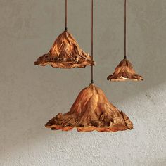 three wooden lights hanging from a ceiling