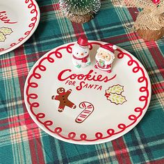 two christmas plates on a plaid tablecloth with cookies for santa written on the plate