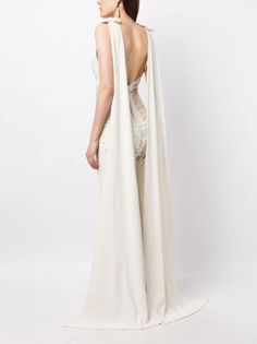 the back of a woman wearing a white gown