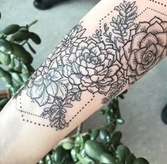 a woman's arm with flowers on it, and dots around the wrist area