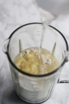 a blender filled with liquid on top of a counter