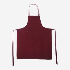 a red apron hanging on a white wall