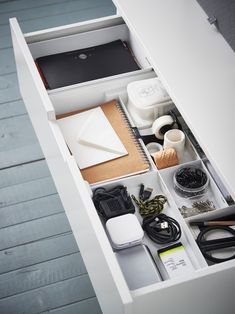 an open drawer with various items in it